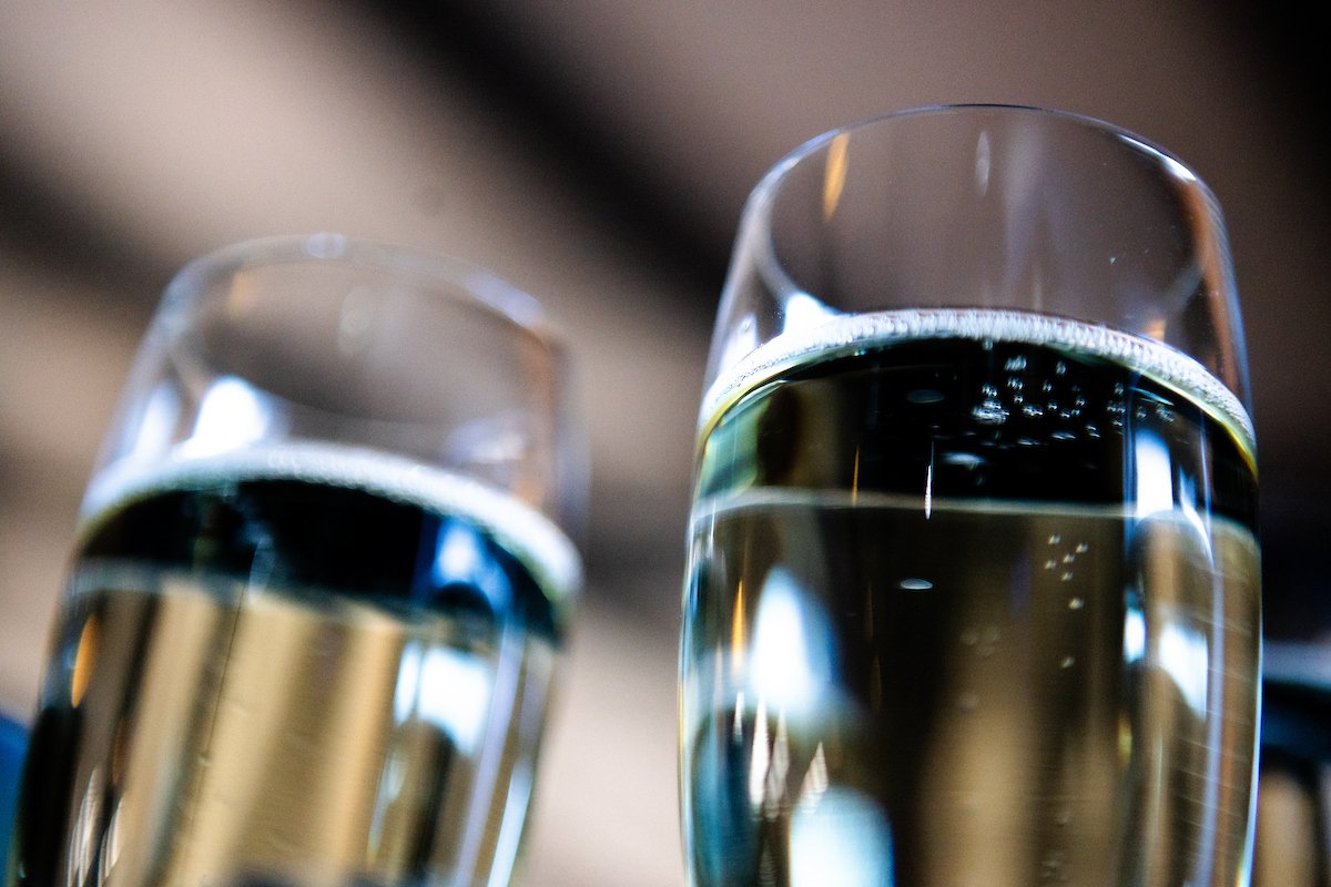 Two champagne glasses filled with bubbly wine, close-up shot.