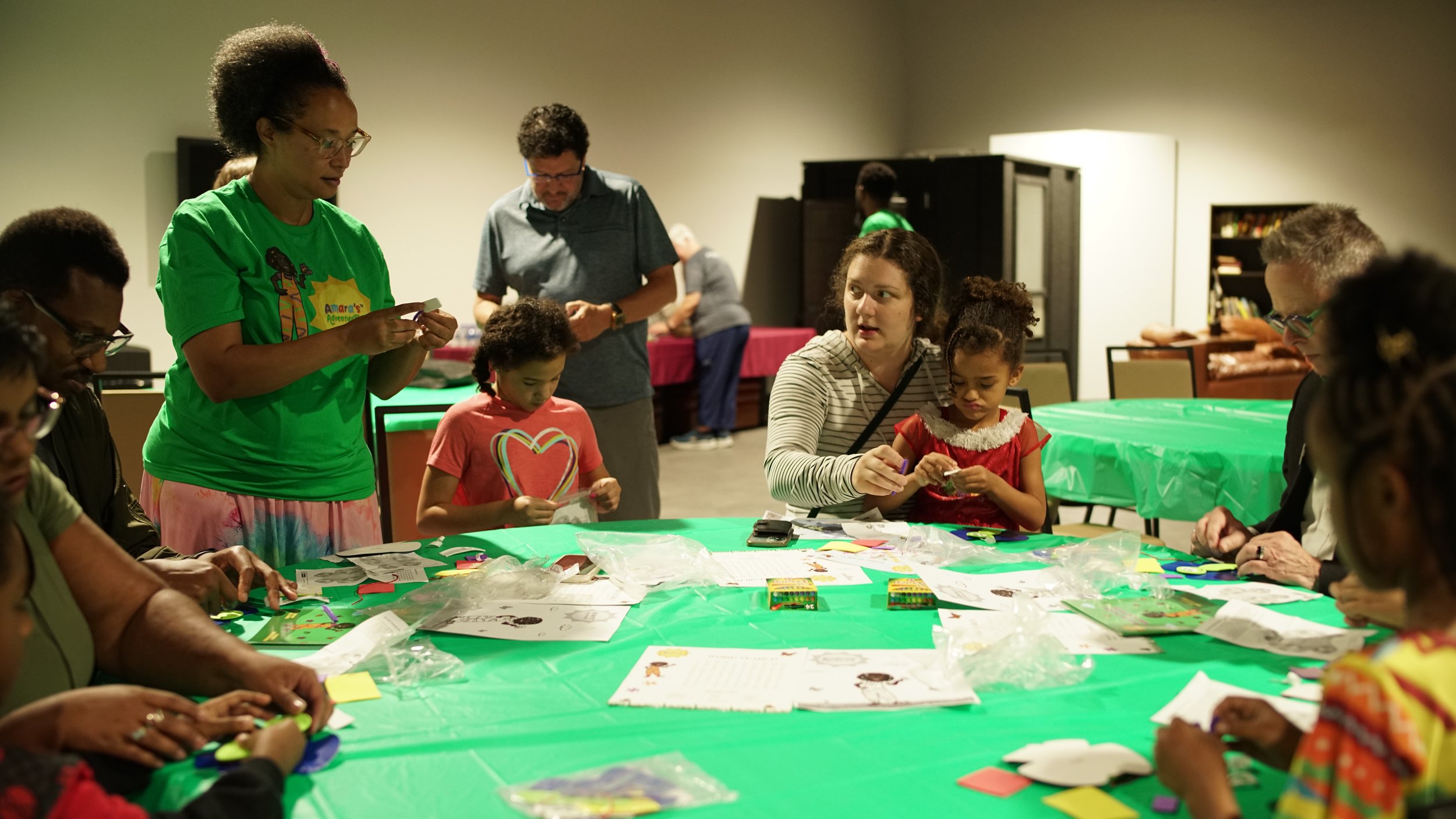 Families and children make butterfly crafts together at the Harrison Museum of African American Culture
