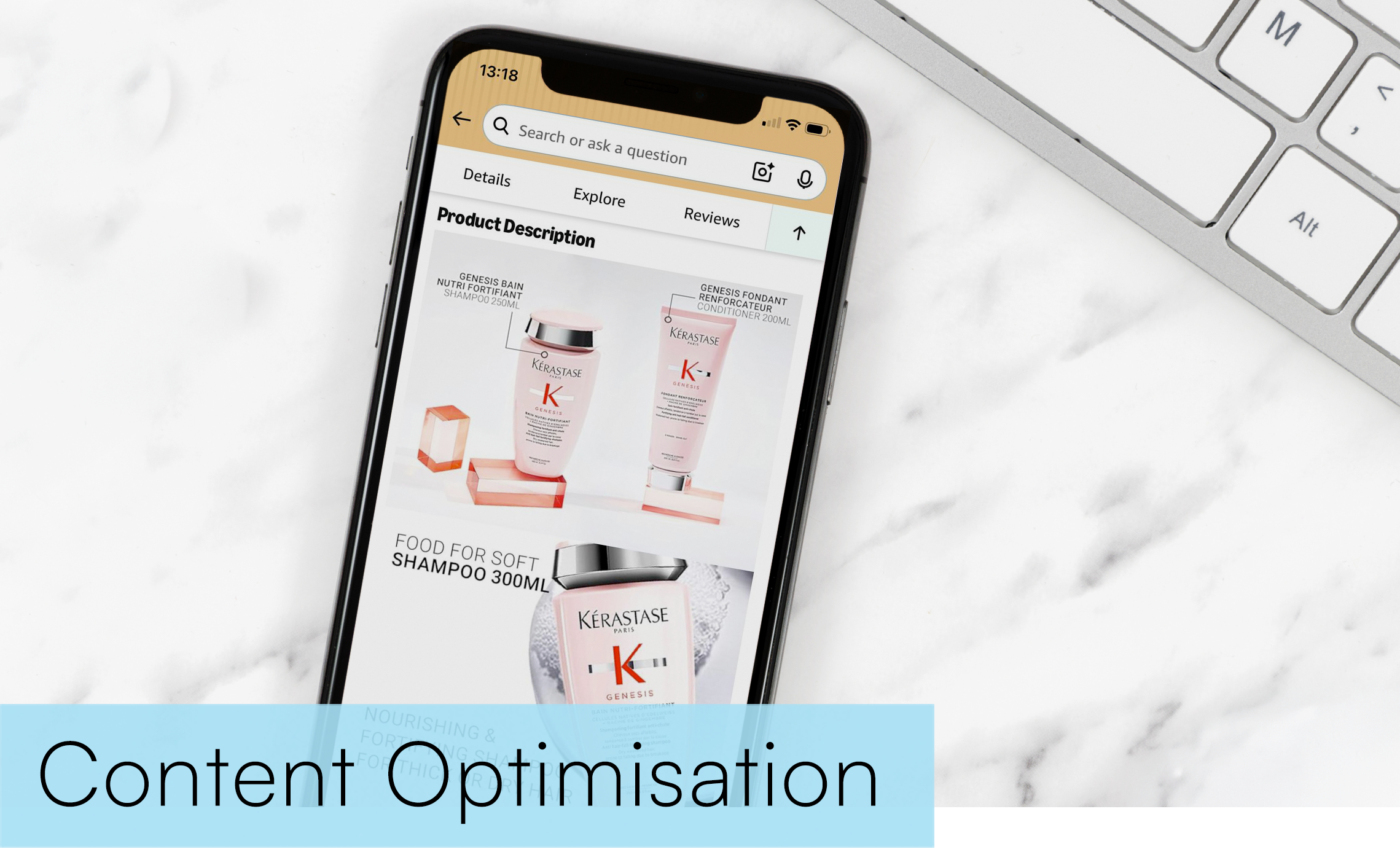 Smartphone on a white marble desk displaying a product page for hair care products with shampoo and conditioner bottles, next to a silver keyboard.