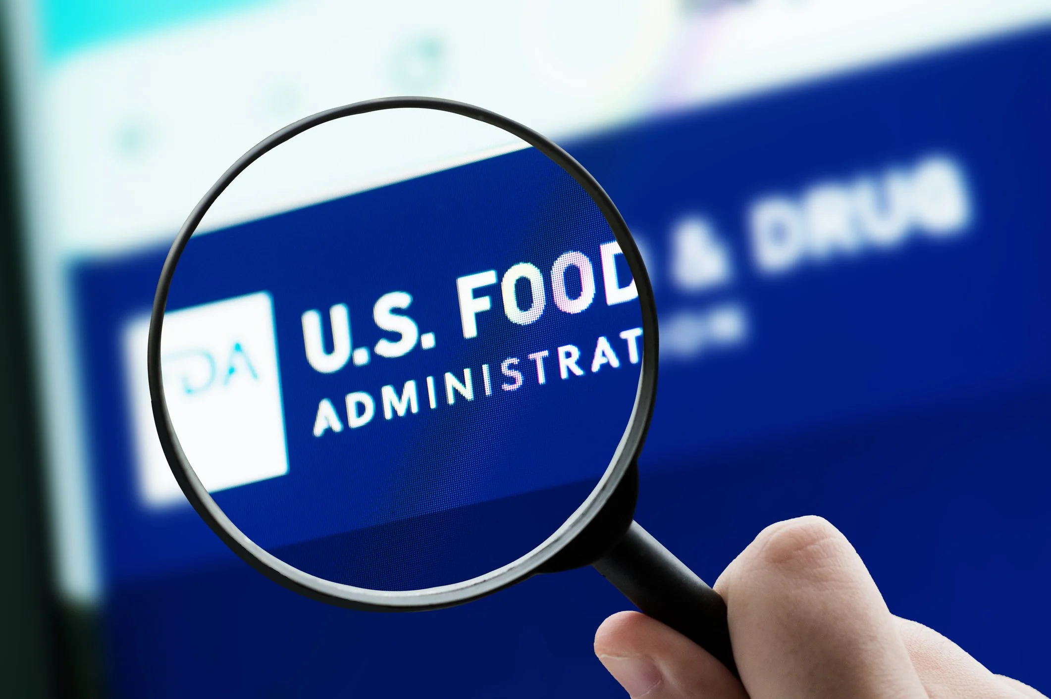 Magnifying glass focusing on the U.S. Food and Drug Administration (FDA)  representing a mock FDA Inspection.