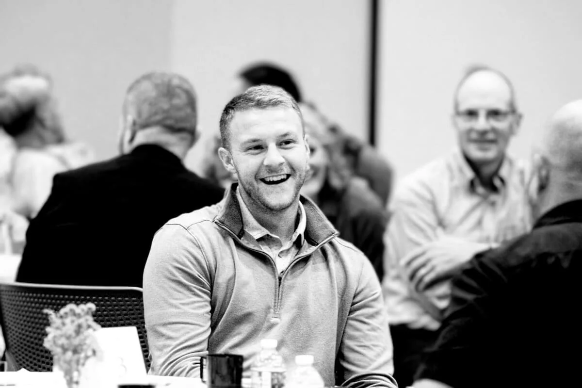 A young man smiles at an event helping to raise awareness for the need of students in Ashland High School
