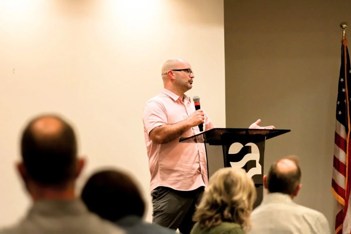 A man speaking about helping serve and volunteer on committees as part of the Young Life ministries.