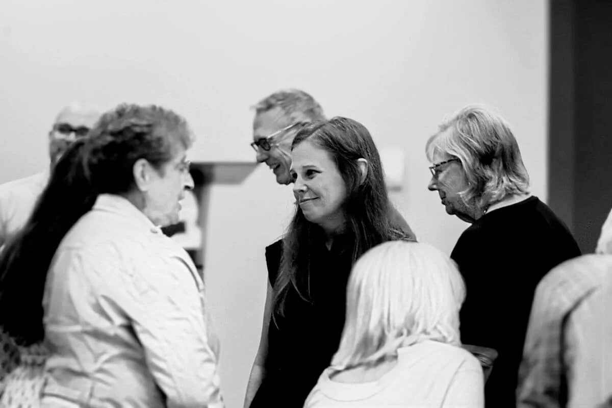 A group of people speaking in a banquet setting to help raise funds for nonprofit Ashland ministries.