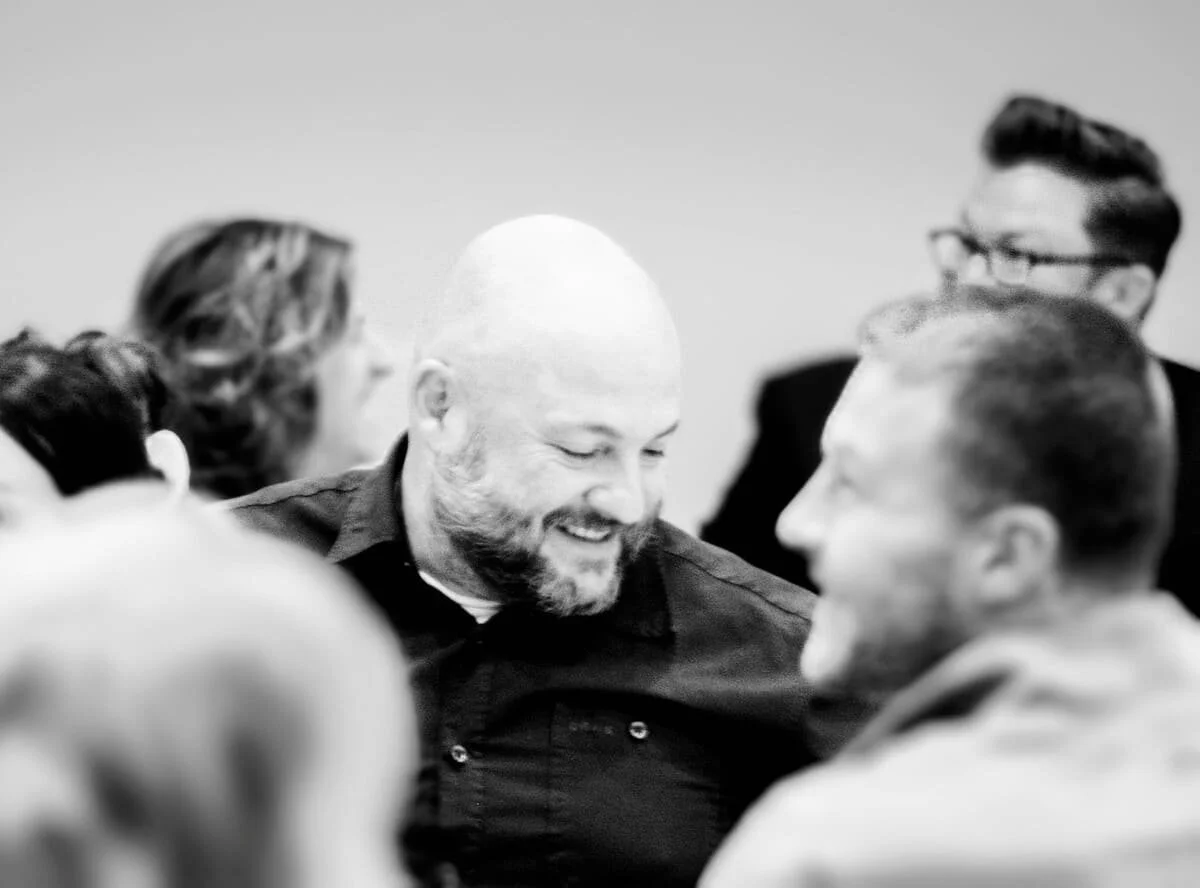 People enjoying conversation about the various ways they reach the community.