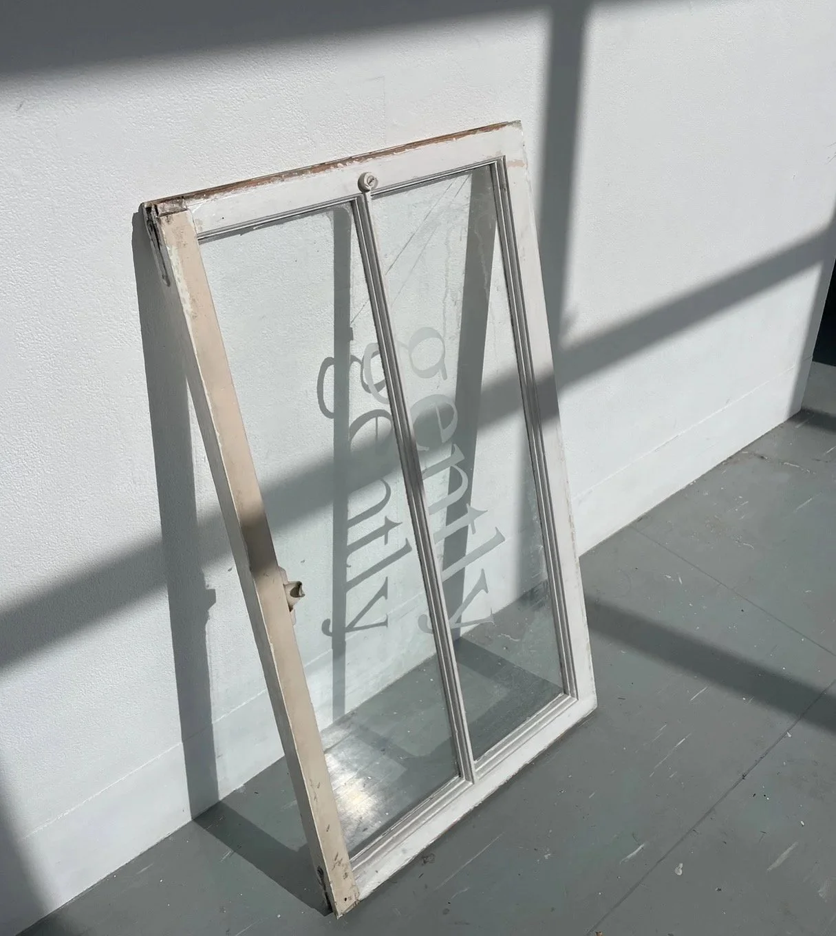 'gently', 2025, etched text, reclaimed sash windows, Melbourne/Naarm  