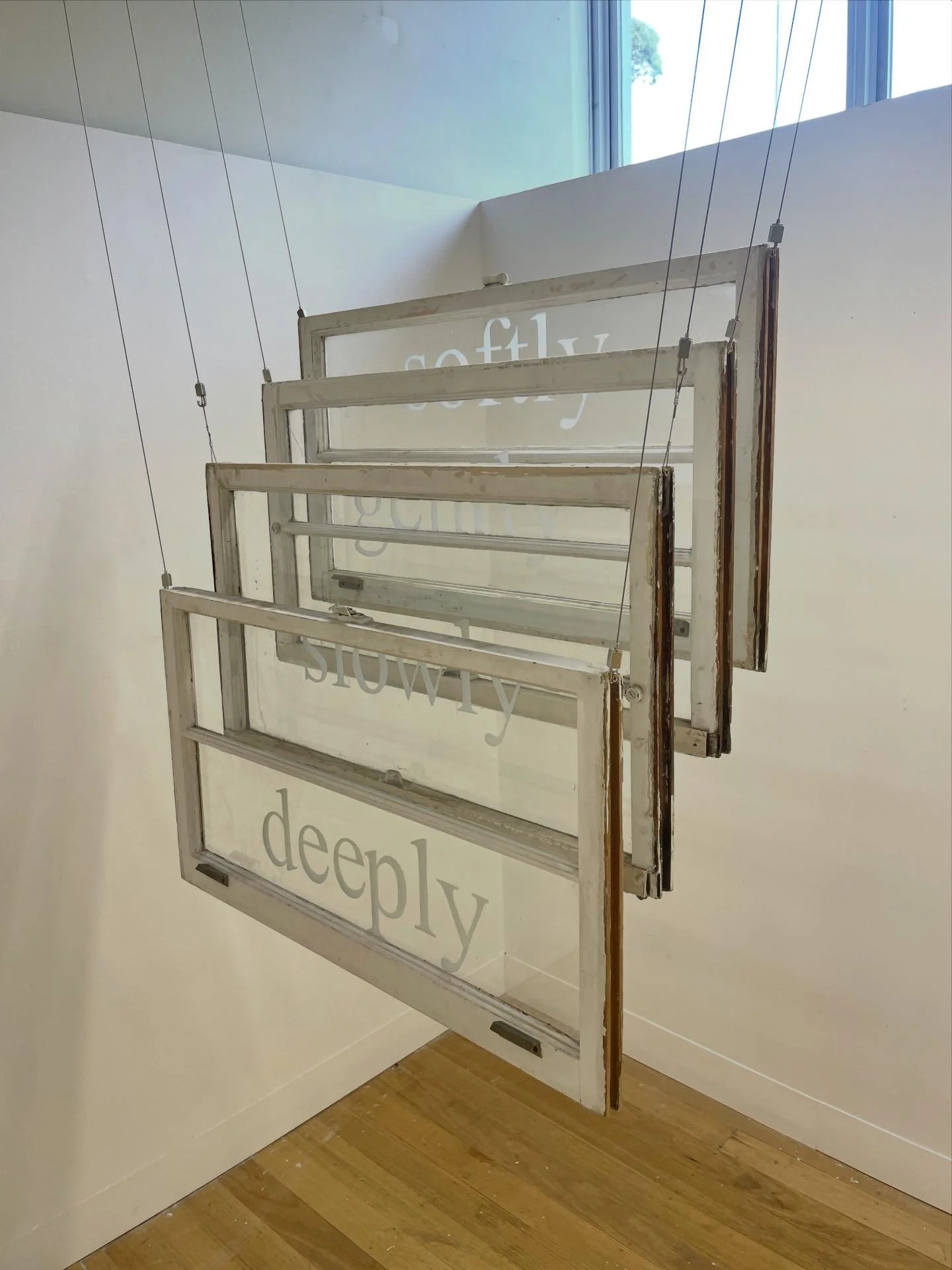 'softly, gently, slowly, deeply' 2025, etched text, reclaimed sash windows, Melbourne/Naarm 
