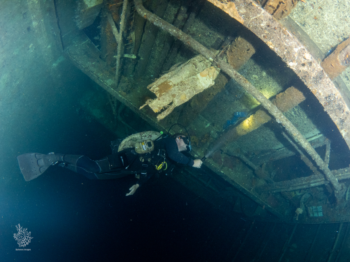 A scuba diver exploring the interior of the Zenobia shipwreck in cyprus.