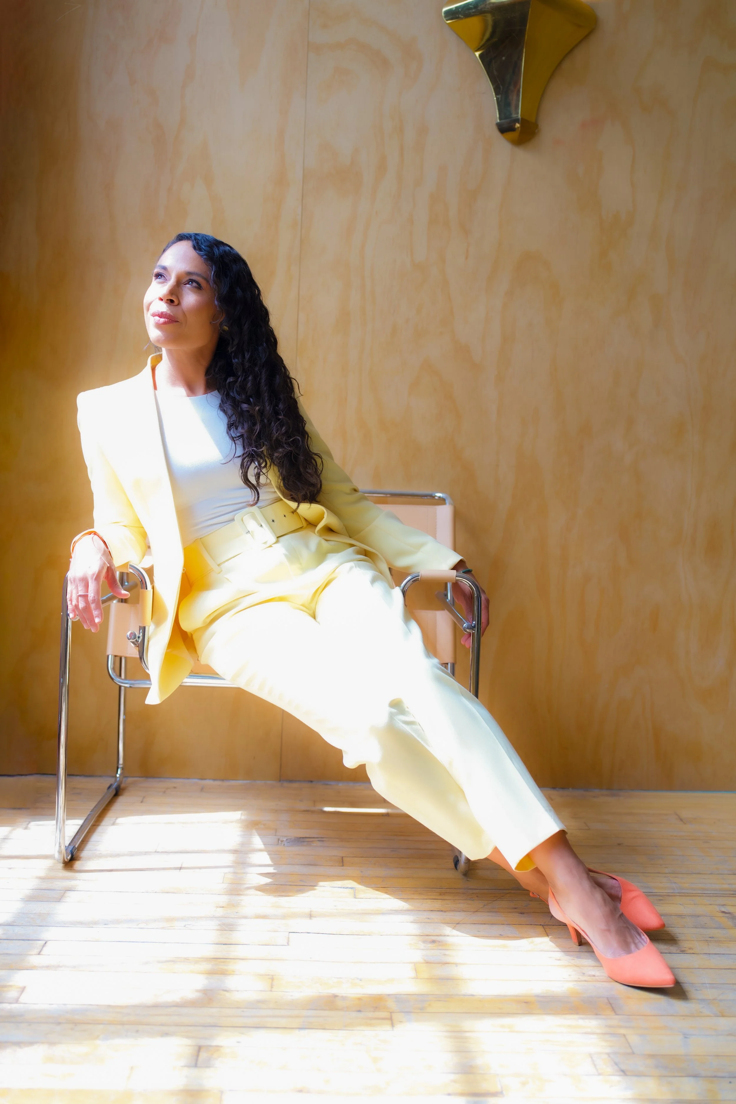 Charlene Lienhart, founder of ViBoA, sitting on a chair during a corporate wellness workshop