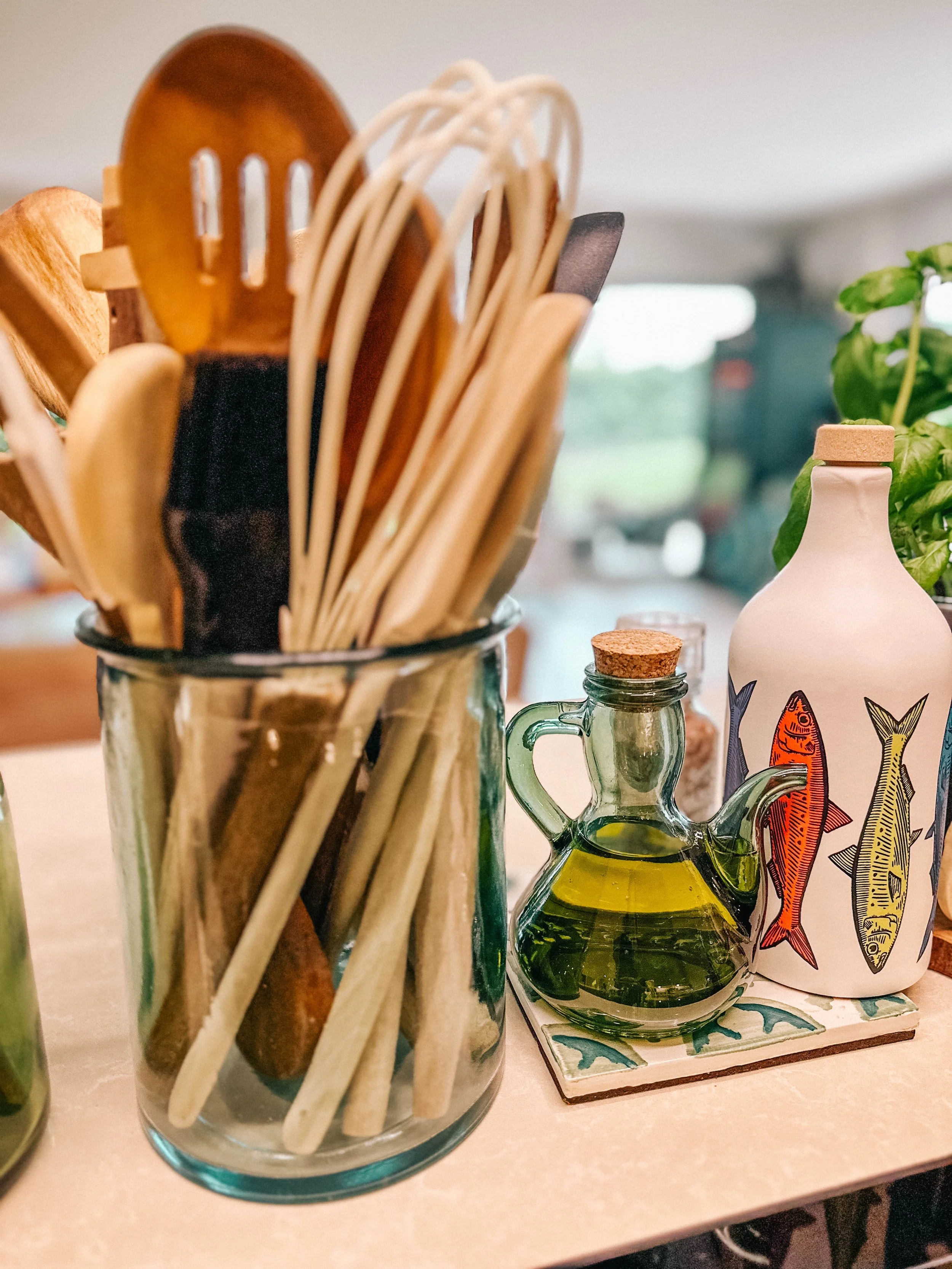 A glass jar filled with wooden kitchen utensils, ViBoA is cooking at home with delicious recipes and with joy