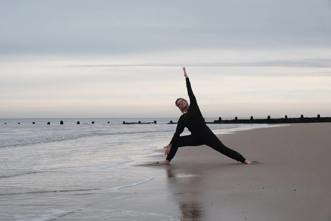 Freedom Yoga & Retreats Director Jax Heffer-Cooke Performing Side bend in Warrior II stance