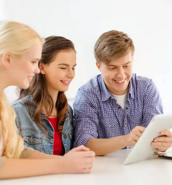 three students looking at tablet for ACT and SAT Prep.