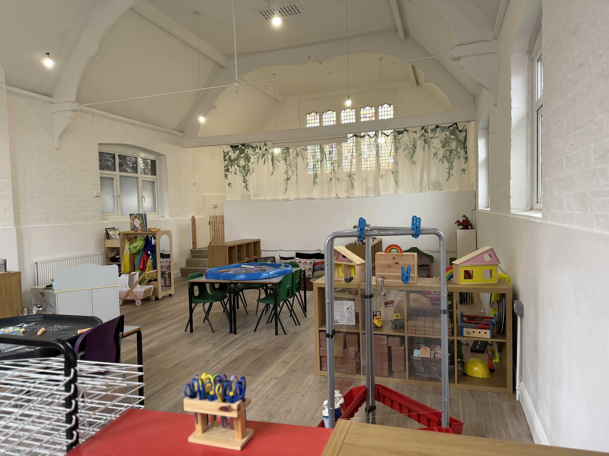 Bright playroom with toys and activity areas at Pop-Up Day Nursery.