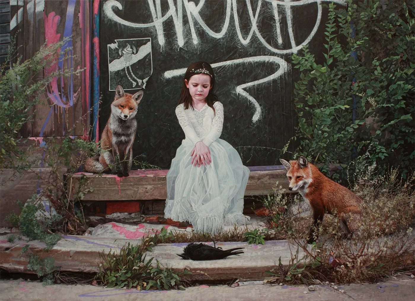 A young girl sits on a wooden platform with her eyes closed, wearing a white dress, flanked by a fox on her left and a fox on her right. There is a blackboard behind her with chalk writing and art, surrounded by plants and graffiti on the fence.