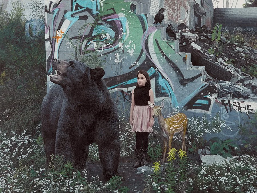 A young girl standing between a bear and a deer in front of a graffitied wall with pigeons on a mound of rubble, surrounded by white flowers and green plants.