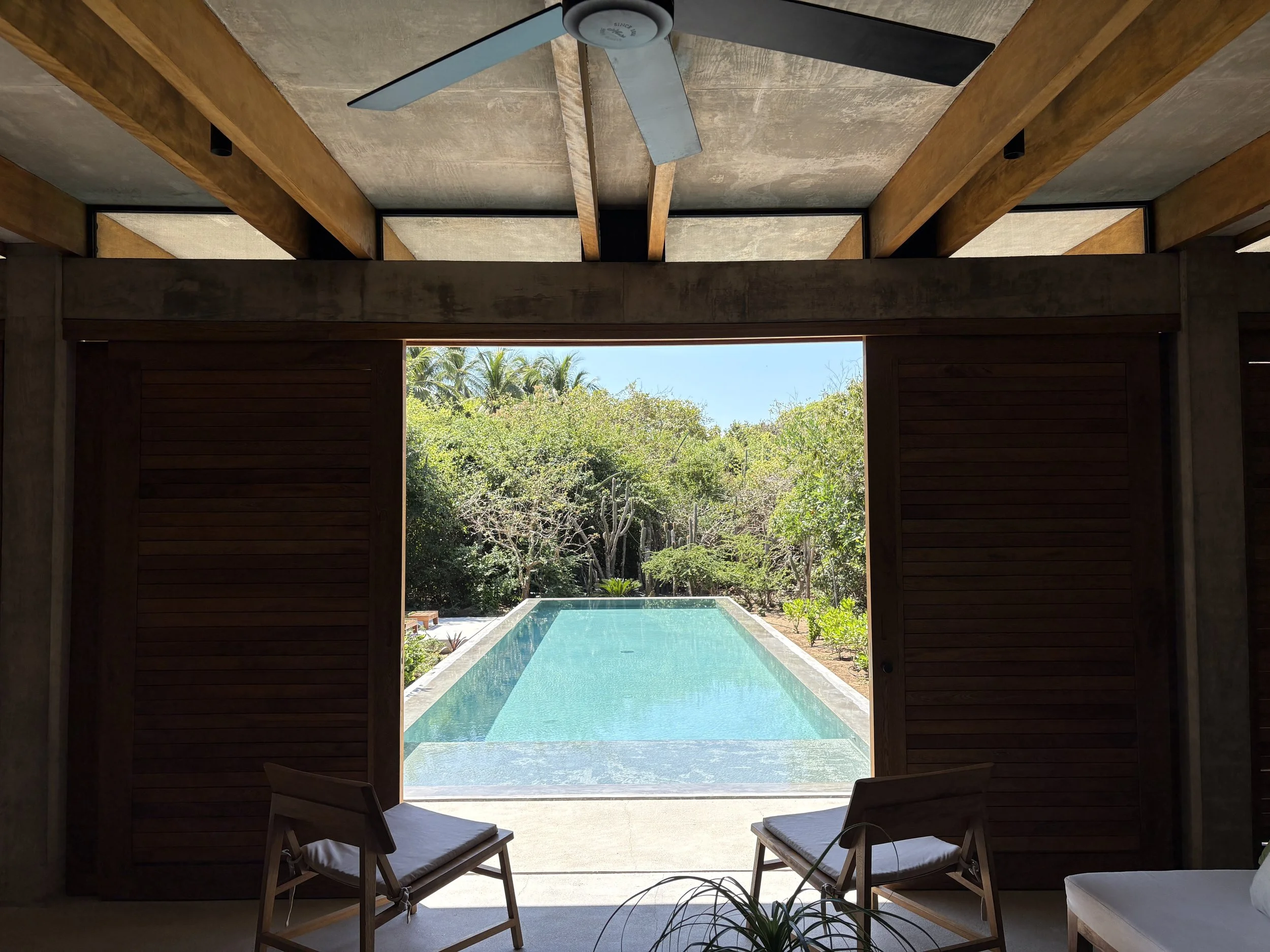 The doors open into the lap pool to extend the space inside
