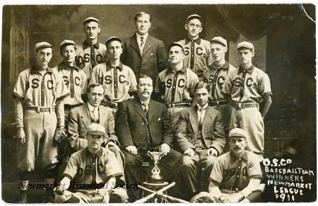 This postcard from 1911 shows a local team from over a century ago, photographed in heavy wool uniforms long before polyester and printed logos. 
The photo is part of the Newmarket Historical Society&rsquo;s collection and captures a time when baseba