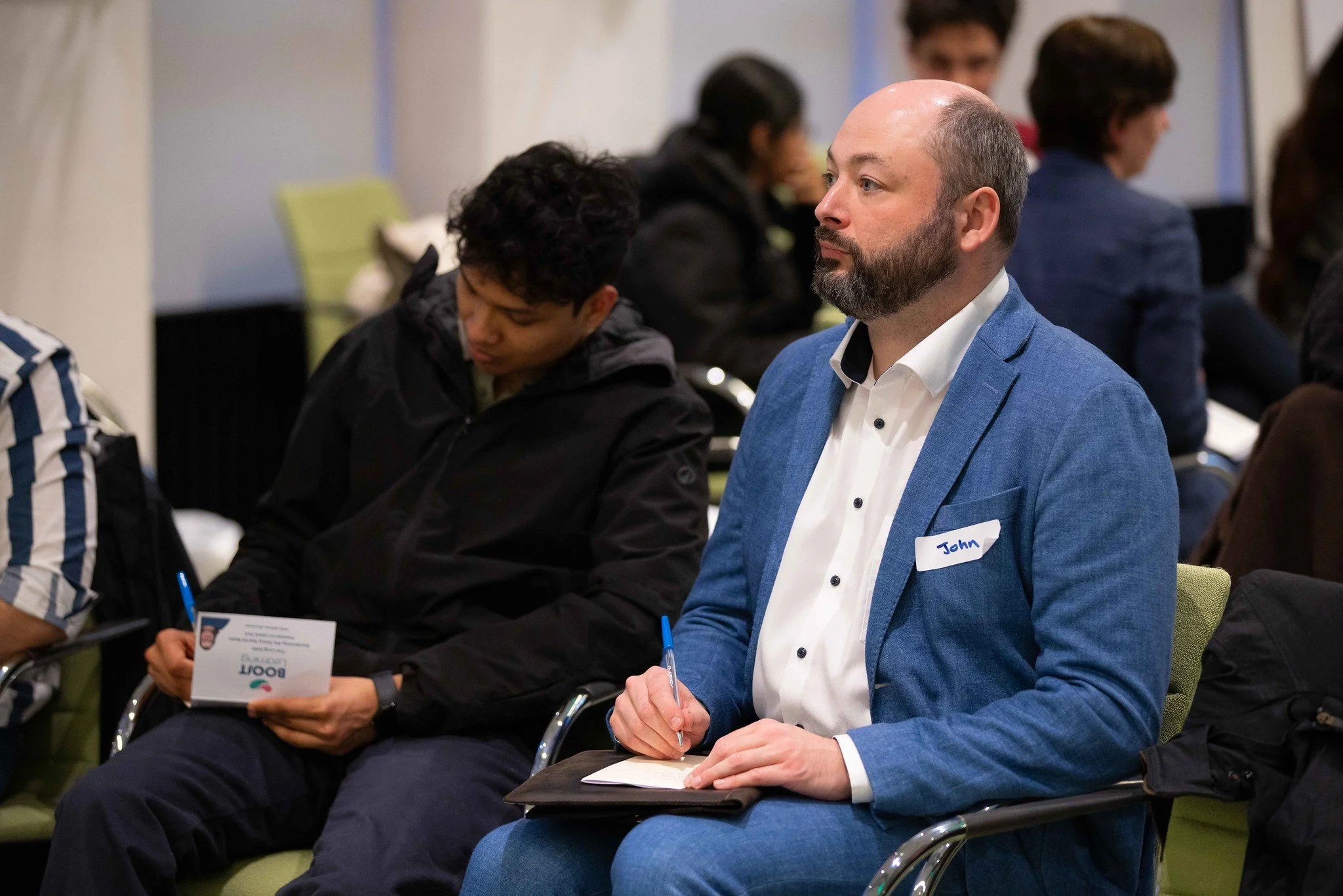 Person speaking with someone on a laptop with an online course in the background