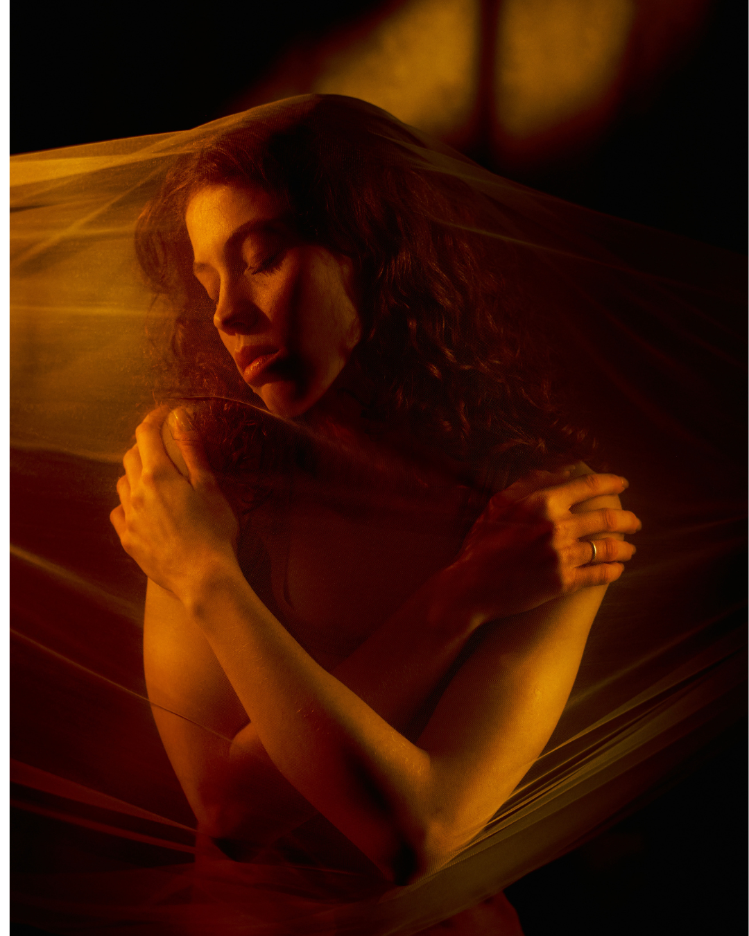 woman holding herself with her eyes closed