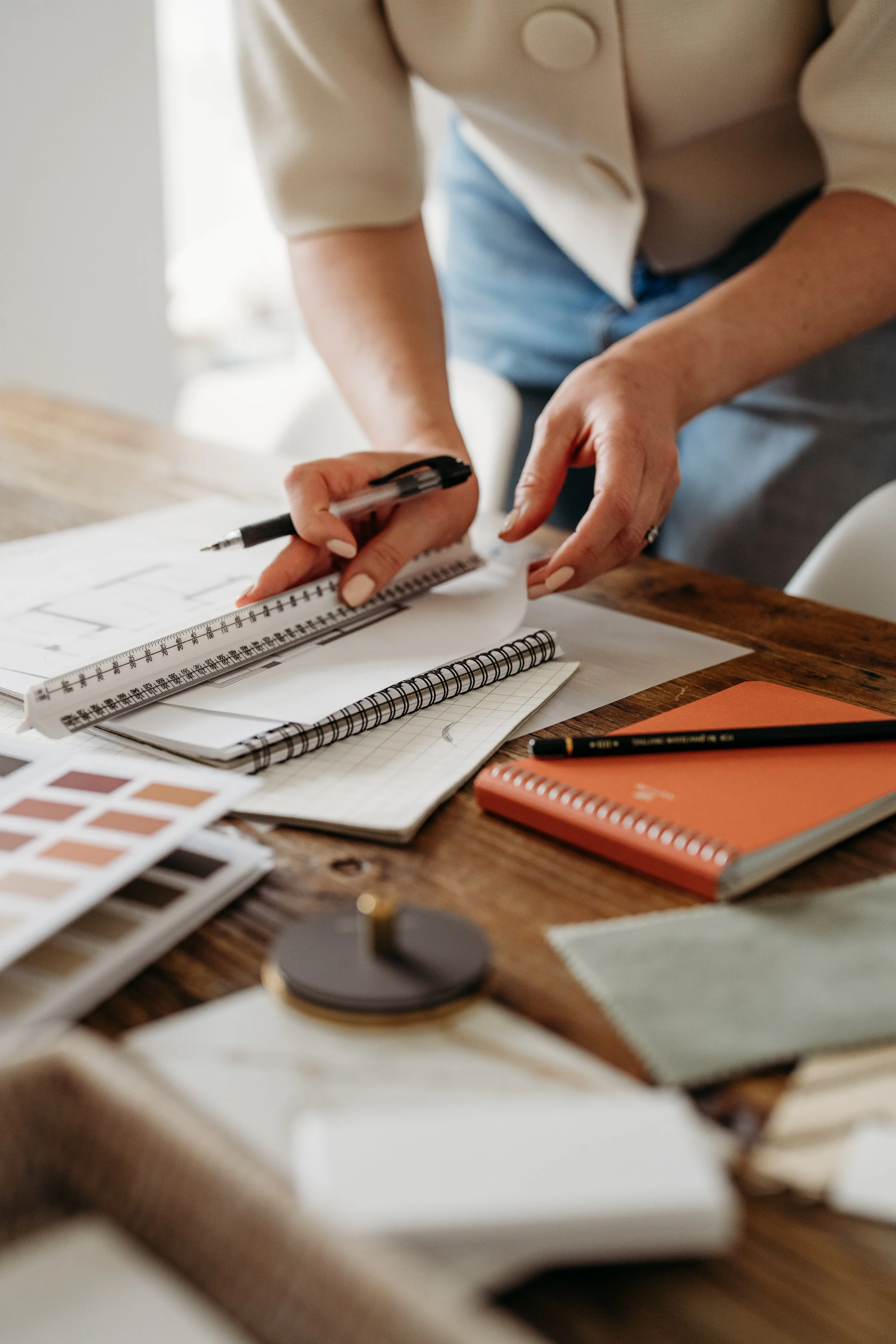 Interior designer working on floor plans and colour samples - Coan Interior Design services