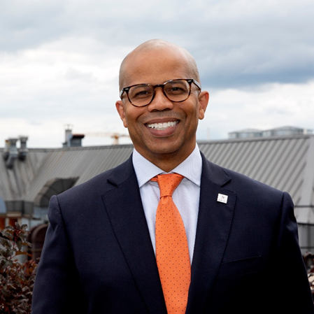 Smiling African-American man in glasses and a dark suit 