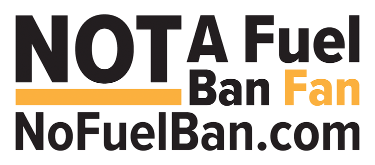 Sign that says 'NOT A Fuel Ban Fan NoFuelBan.com' with bold black and orange text.