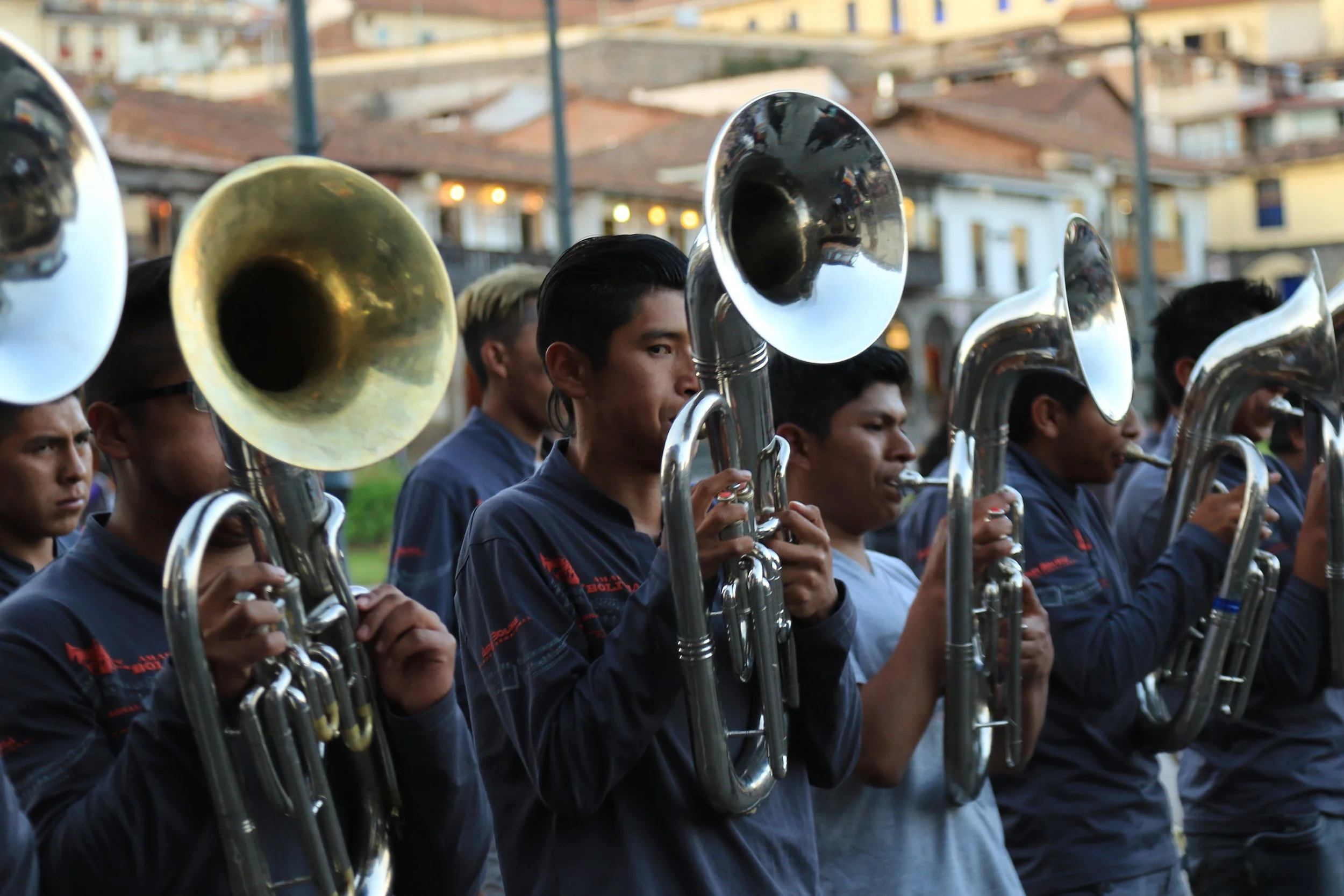 Young musicians playing brass instruments in a parade or outdoor performance