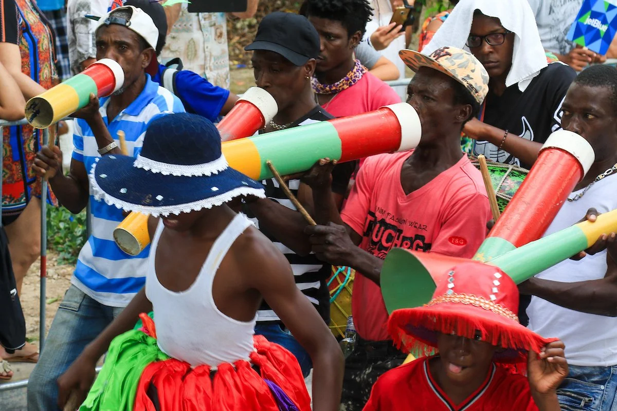 People playing traditional musical instruments in a lively outdoor festival or celebration.