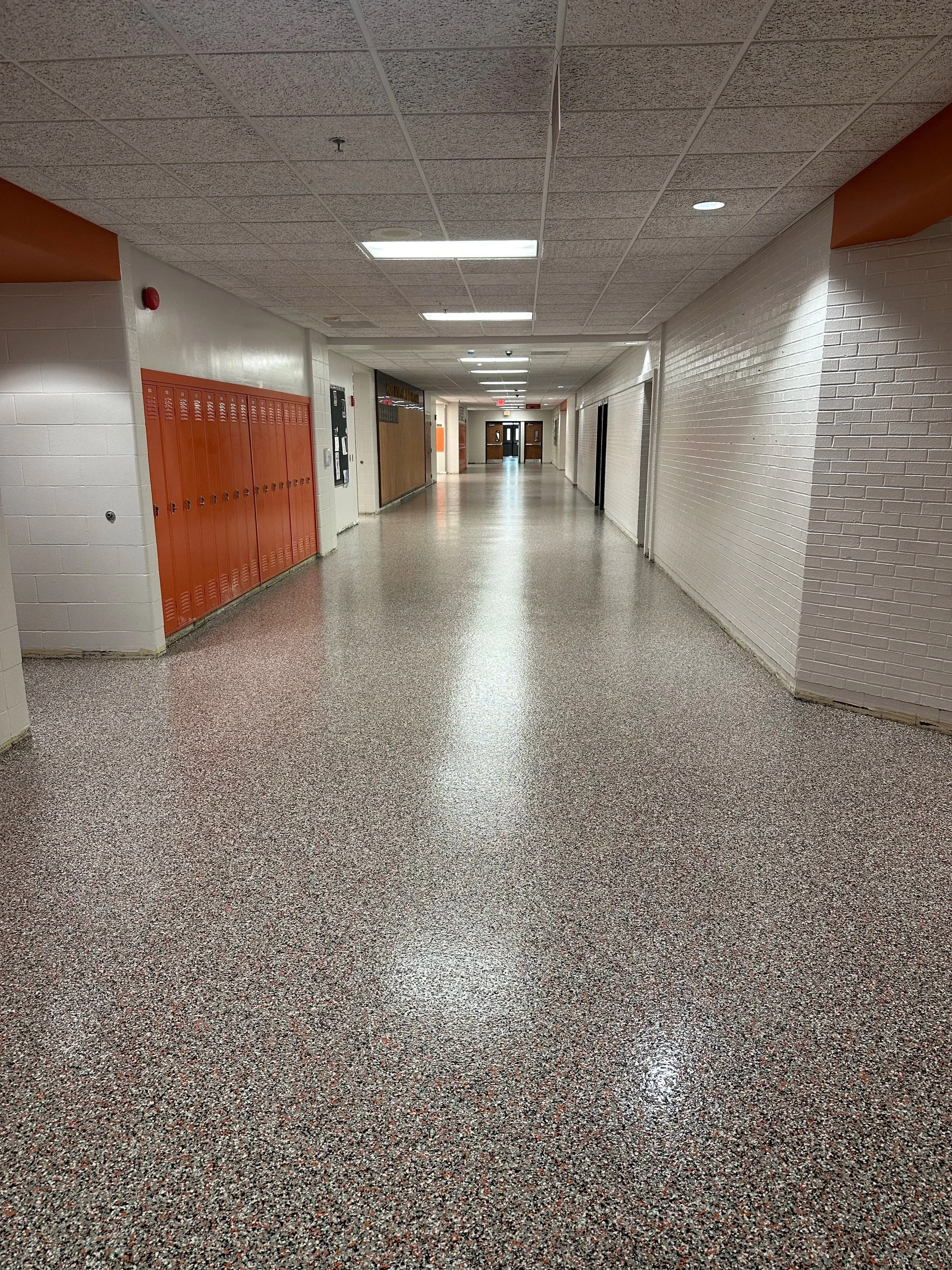Epoxy coated flooring in Kansas City school or commercial hallway with seamless high gloss finishes
