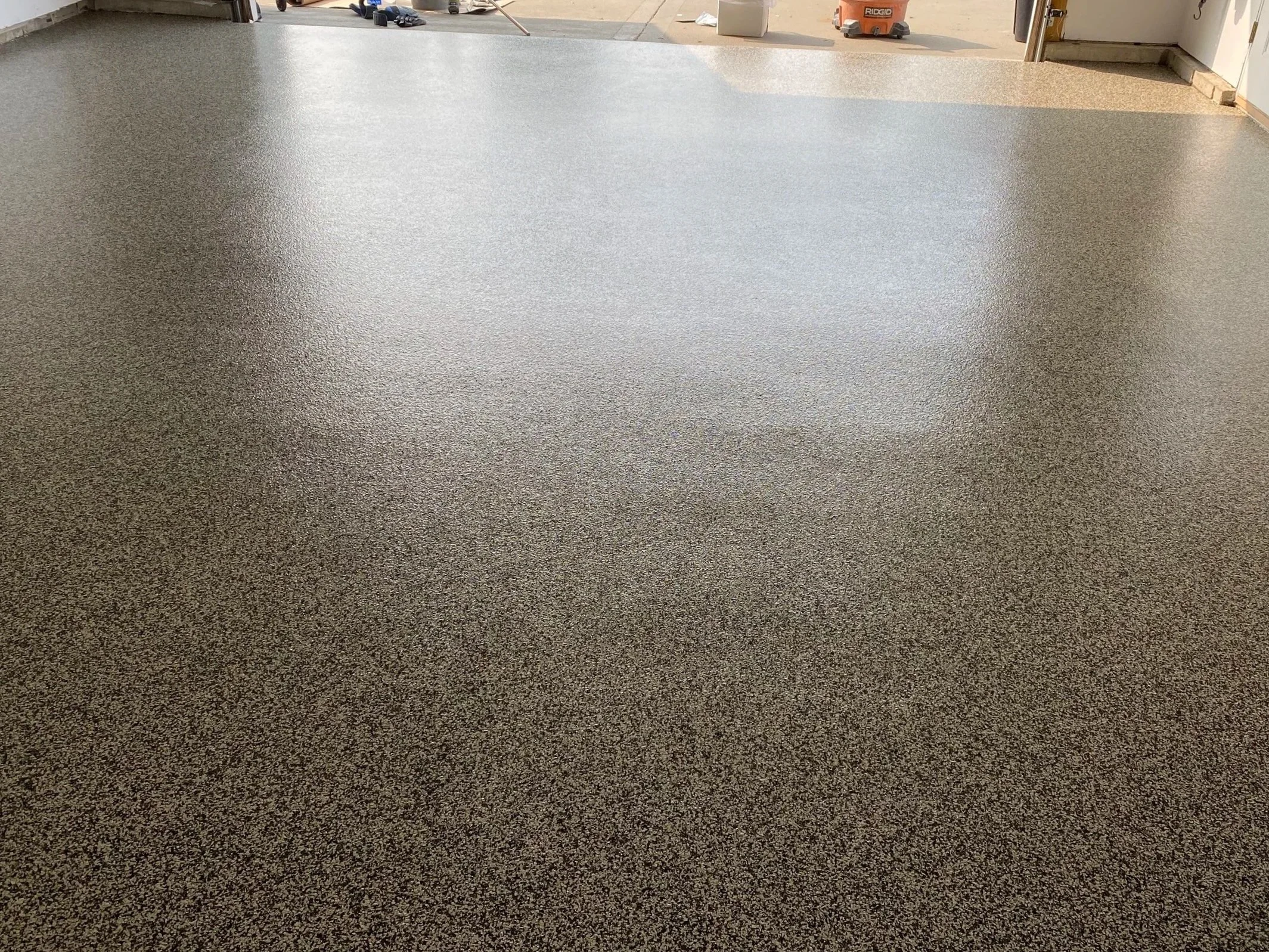 Epoxy garage floor in Kansas City with clean seamless finish by Precision KC Coatings  