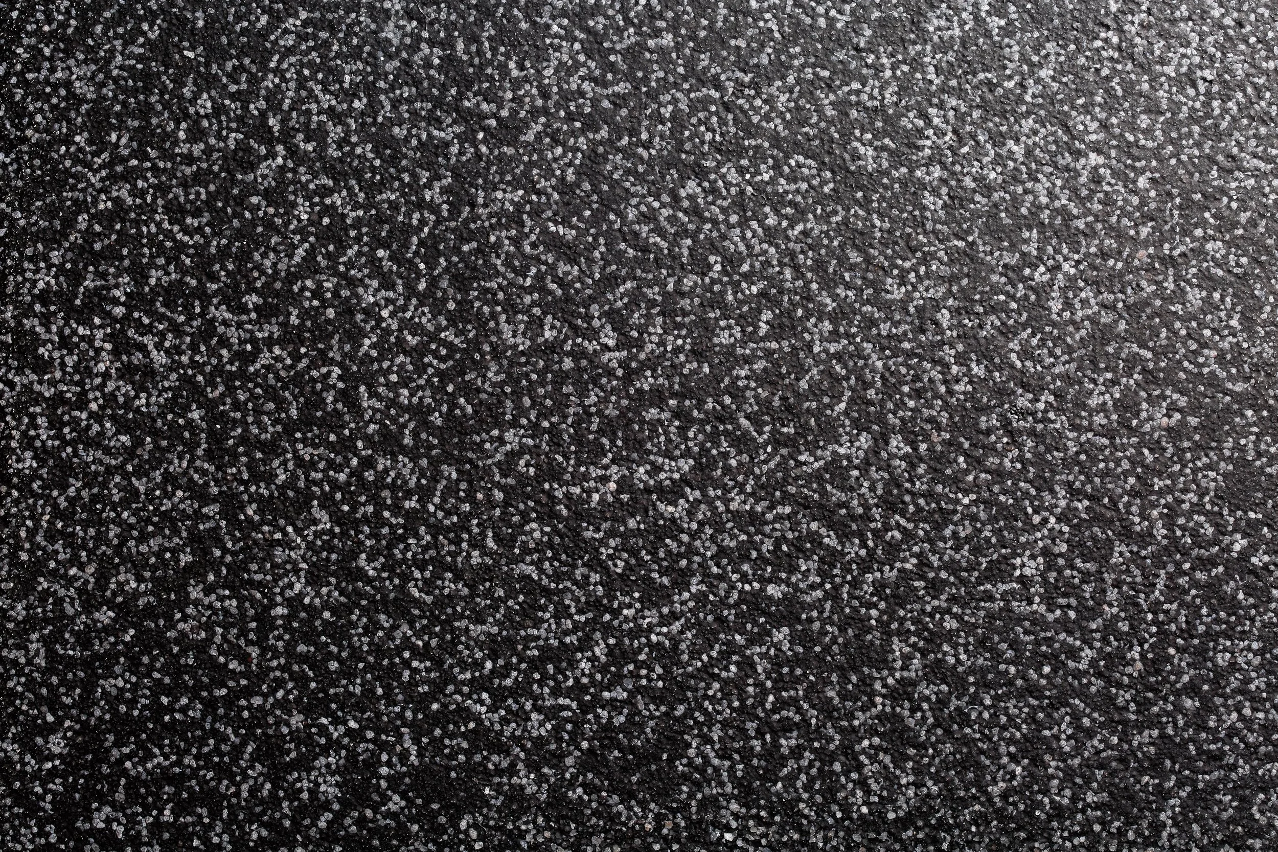 Close-up of a black or dark  flake or quartz epoxy flooring texture used in Kansas City commercial installations by PKC