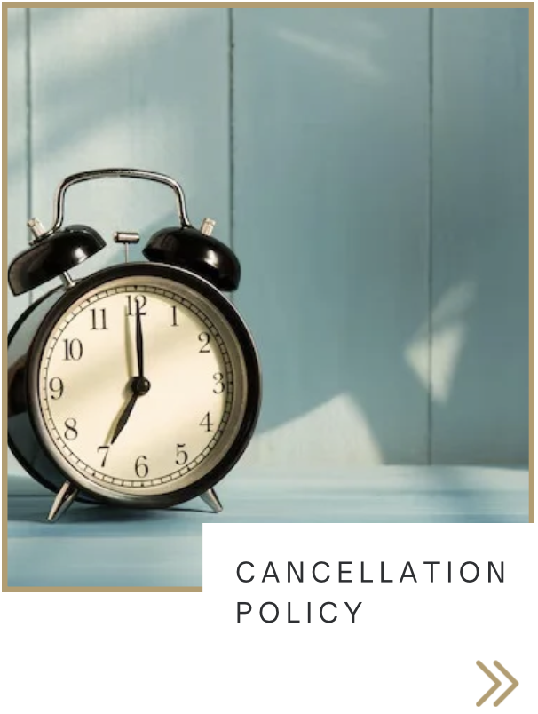 Black vintage alarm clock showing 12:00 on a light blue surface with a blue wall in the background, labeled 'CANCELLATION POLICY' at the bottom.