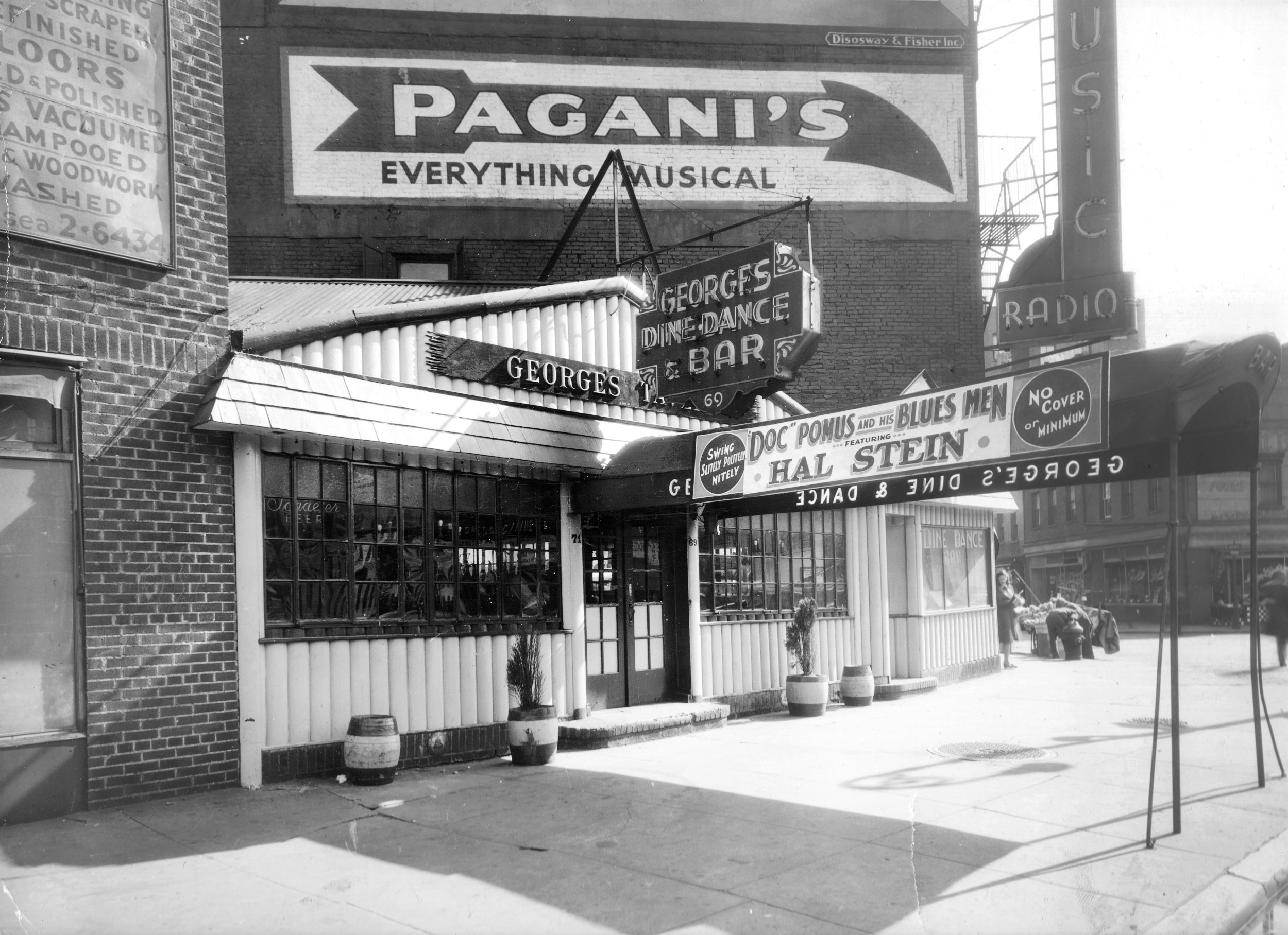 A vintage photograph of George's Tavern with Doc Pomus and His Blues Men on the marquee, Greenwich Village, New York, 1943.