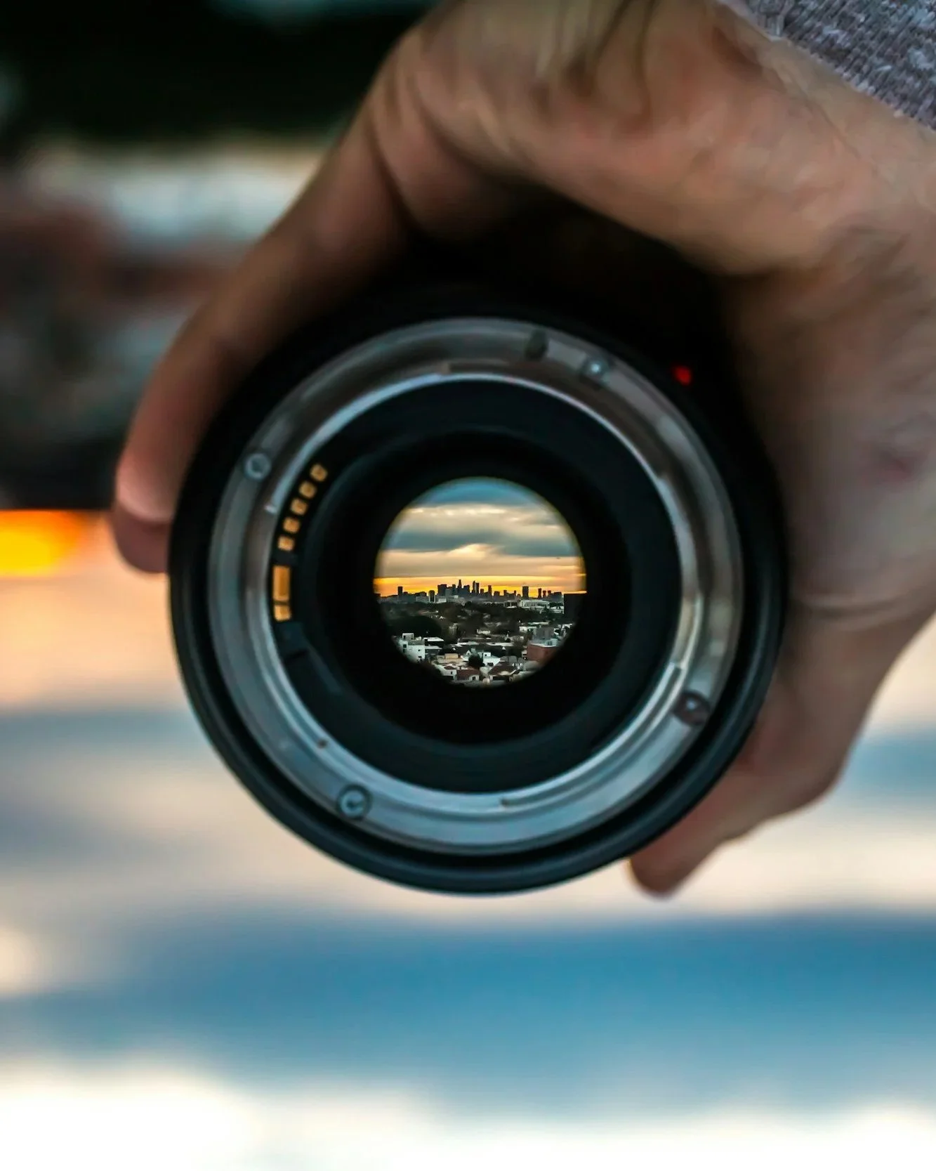 City skyline viewed through the lens of a camera.