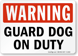 Warning sign reading 'Guard Dog on Duty' with red and black text on a white background.
