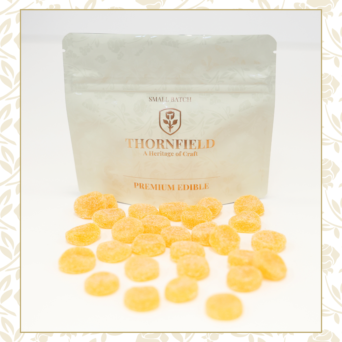A resealable bag labeled 'Thornfield Premium Edible' with dried yellow edible confections spread in front of it on a white background.