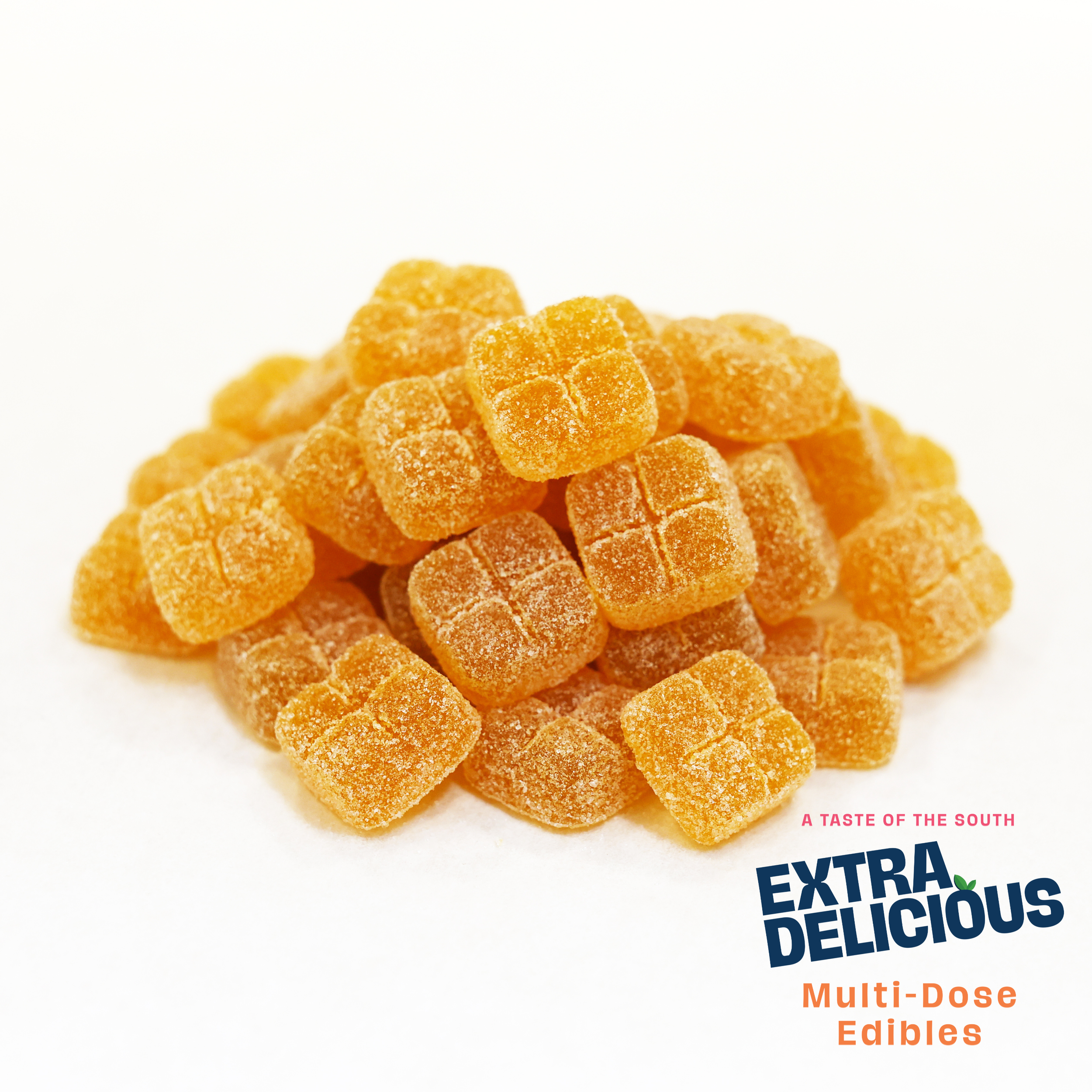 Orange-flavored gummy candies in a pile on a white background with text that reads "Extra Delicious," "Multi-Dose Edibles," and "A Taste of the South."