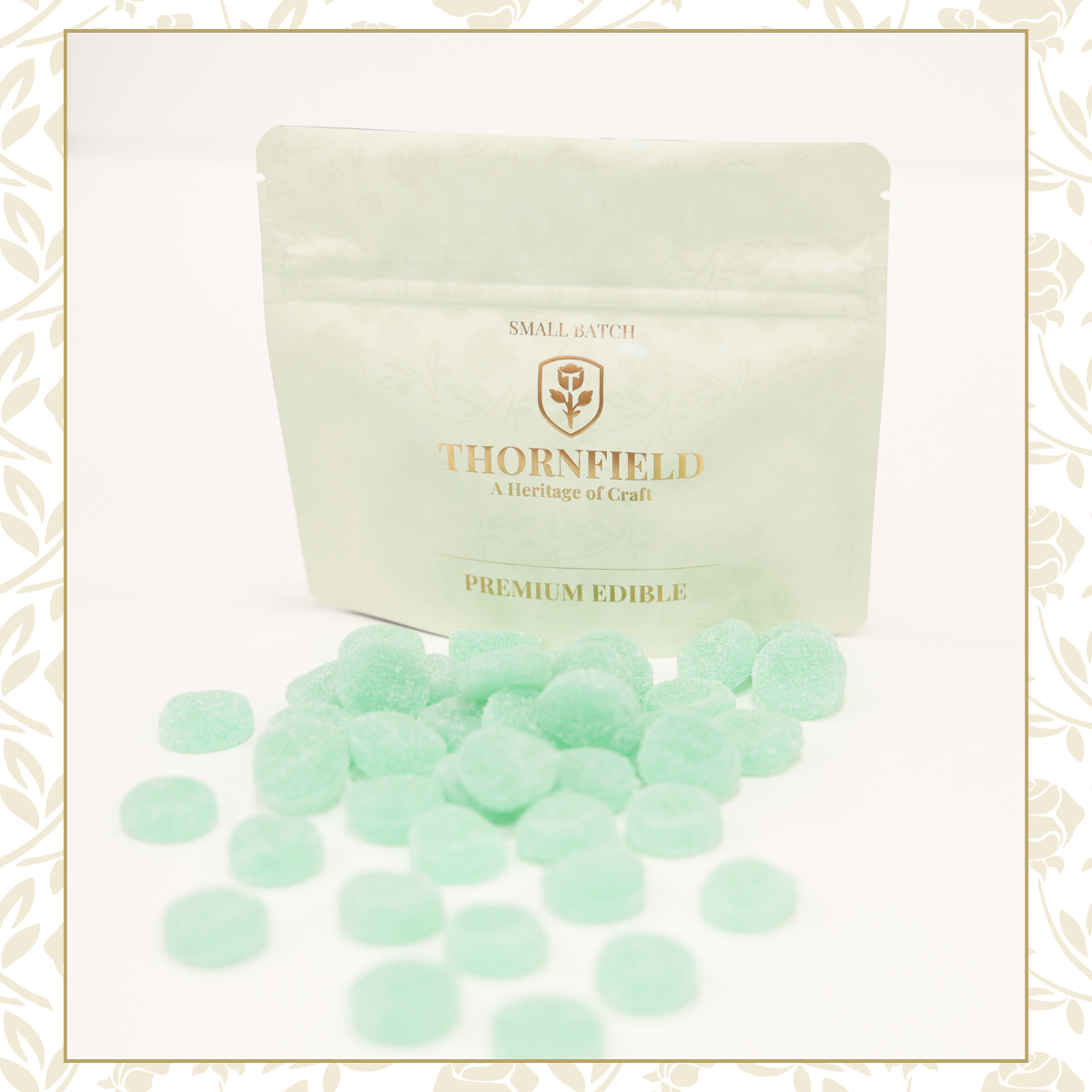 Green candy pieces in front of a resealable bag labeled 'Thornfield Premium Edible' with a logo and decorative gold text.