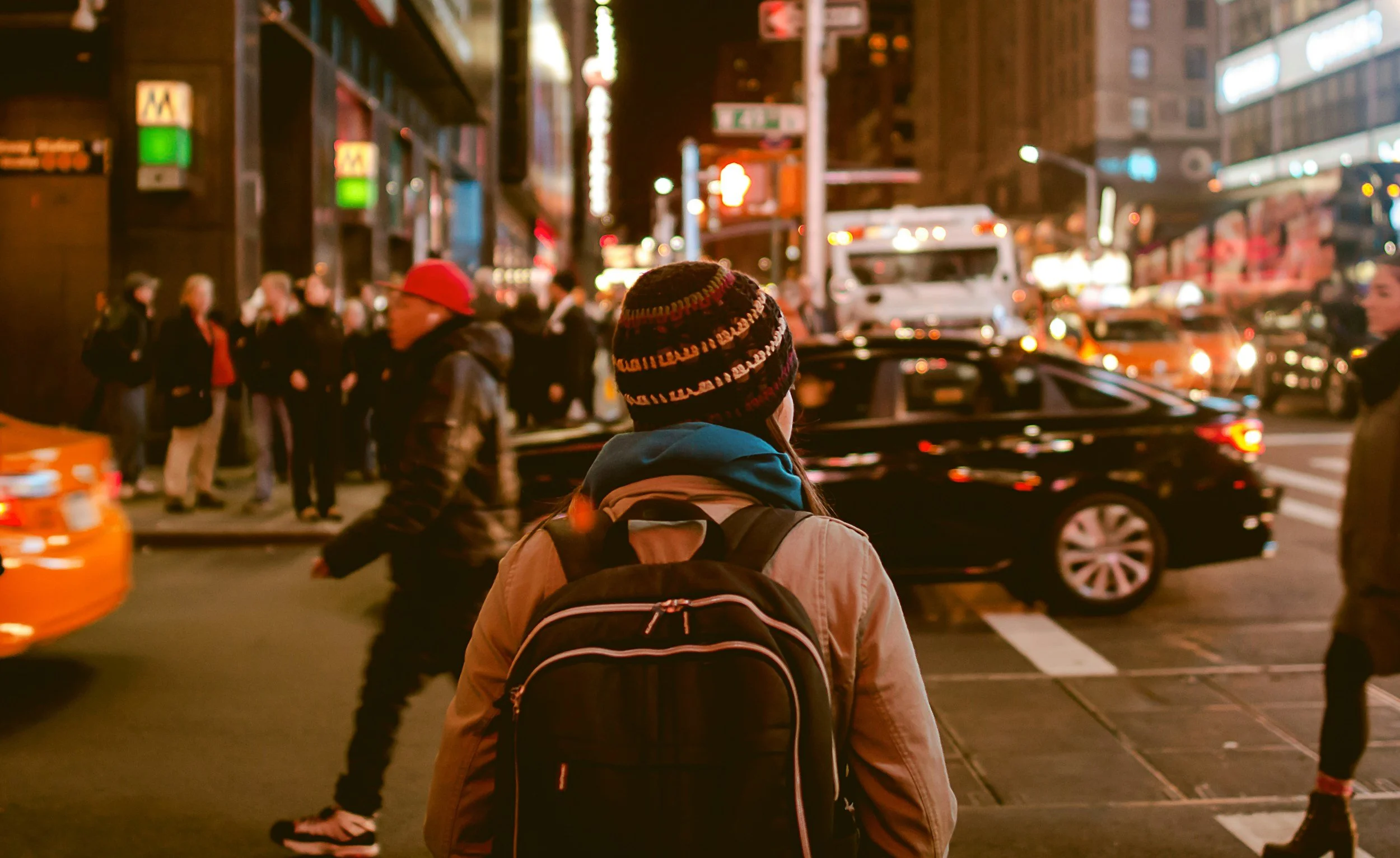 Person with a backpack in a busy public area