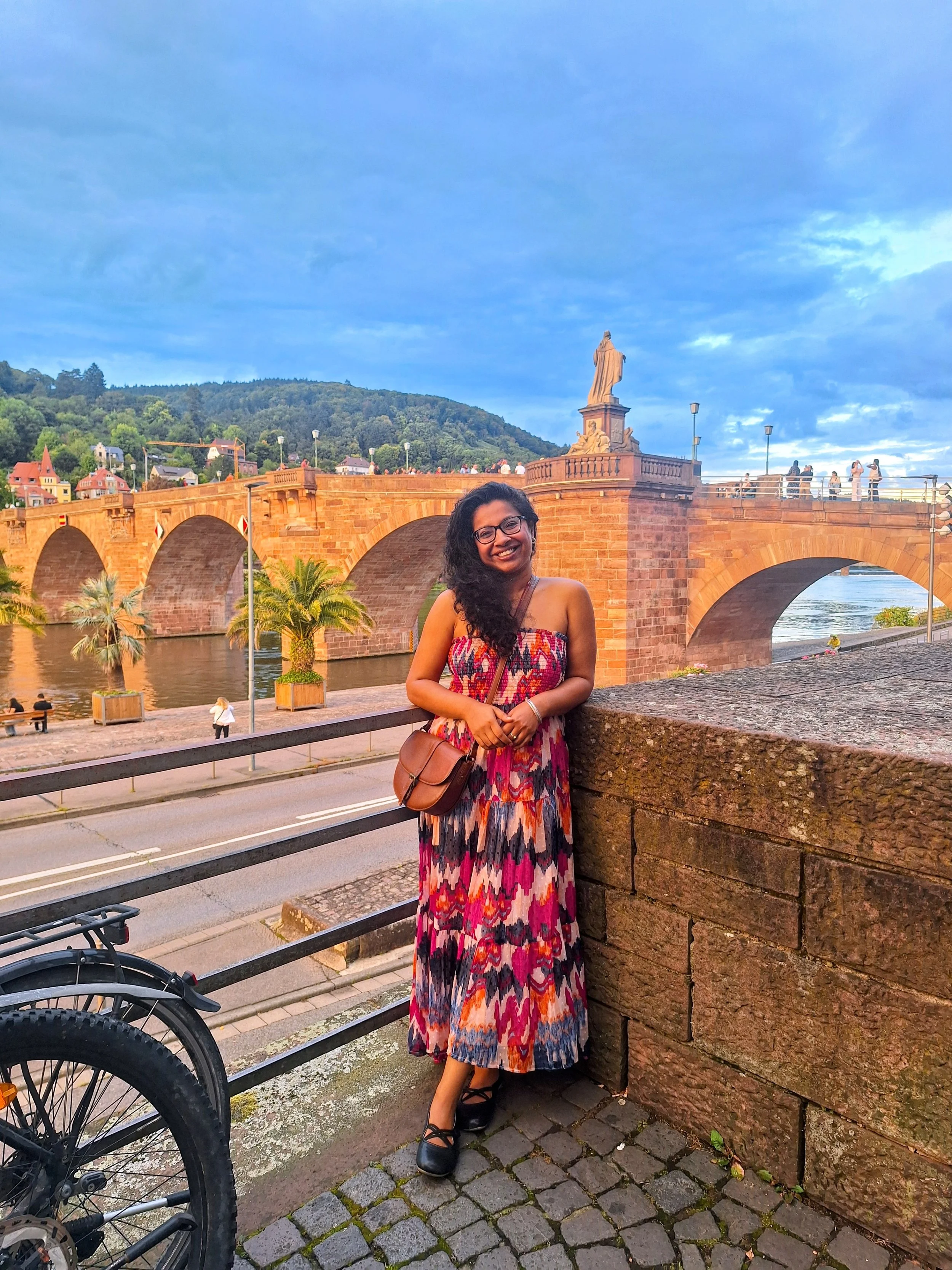 Dr. Pallabi Roy,  sex, intimacy, & relationship coach in front of the old bridge in Heidelberg , Germany