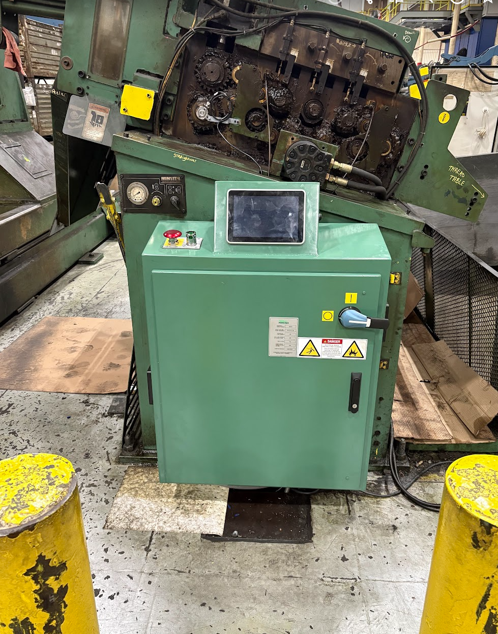 Industrial machine with digital control panel in a factory setting.