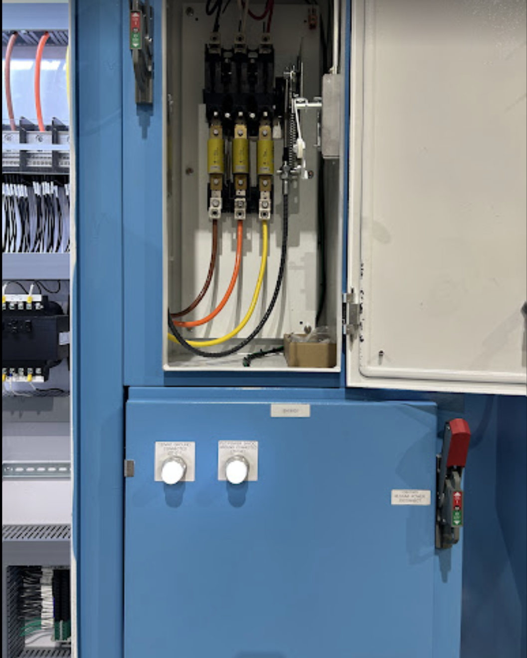 Electrical control panel with colored wires and switches.