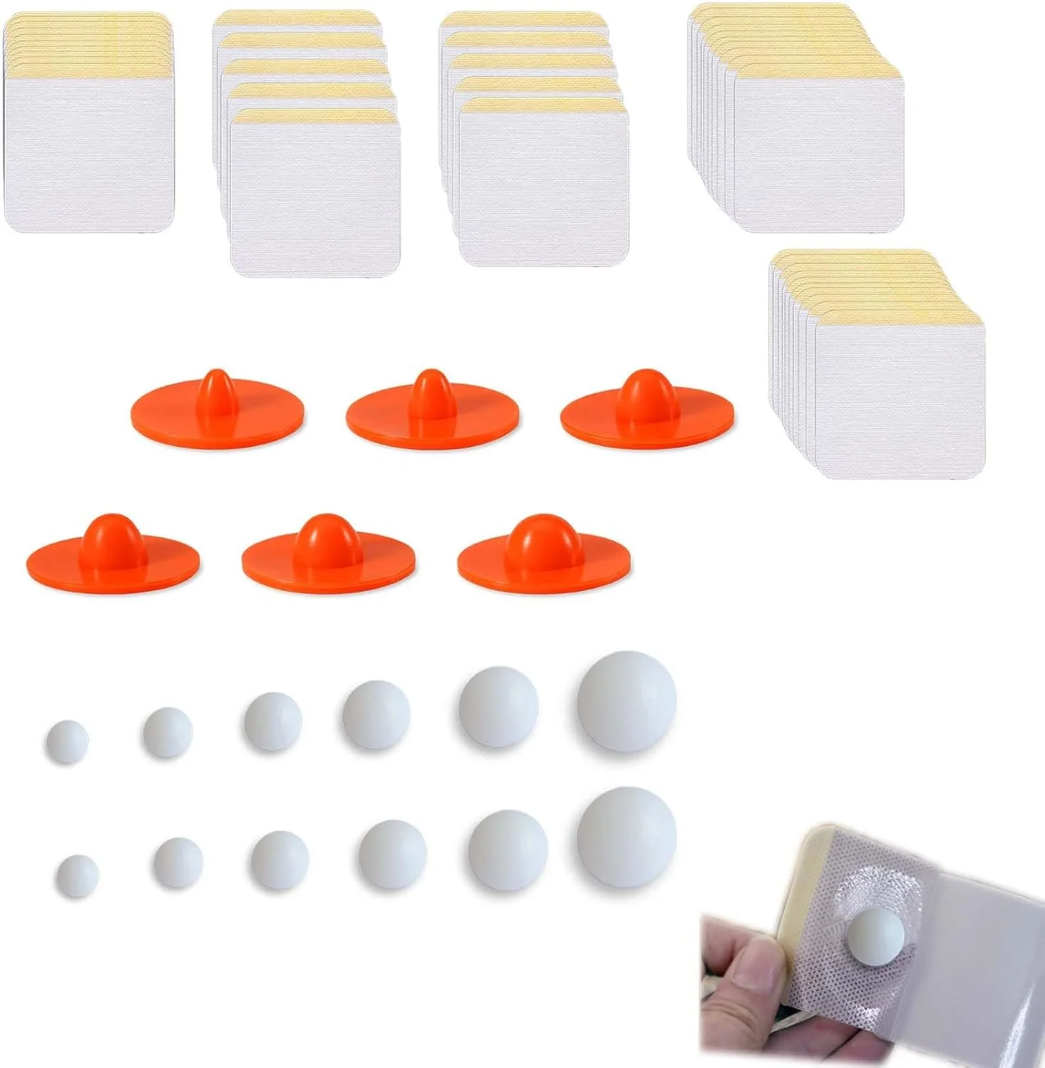 Set of game pieces including white balls in varying sizes, orange paddles with handles, and cards with rounded corners, along with a hand holding a card with a white ball attached to it.