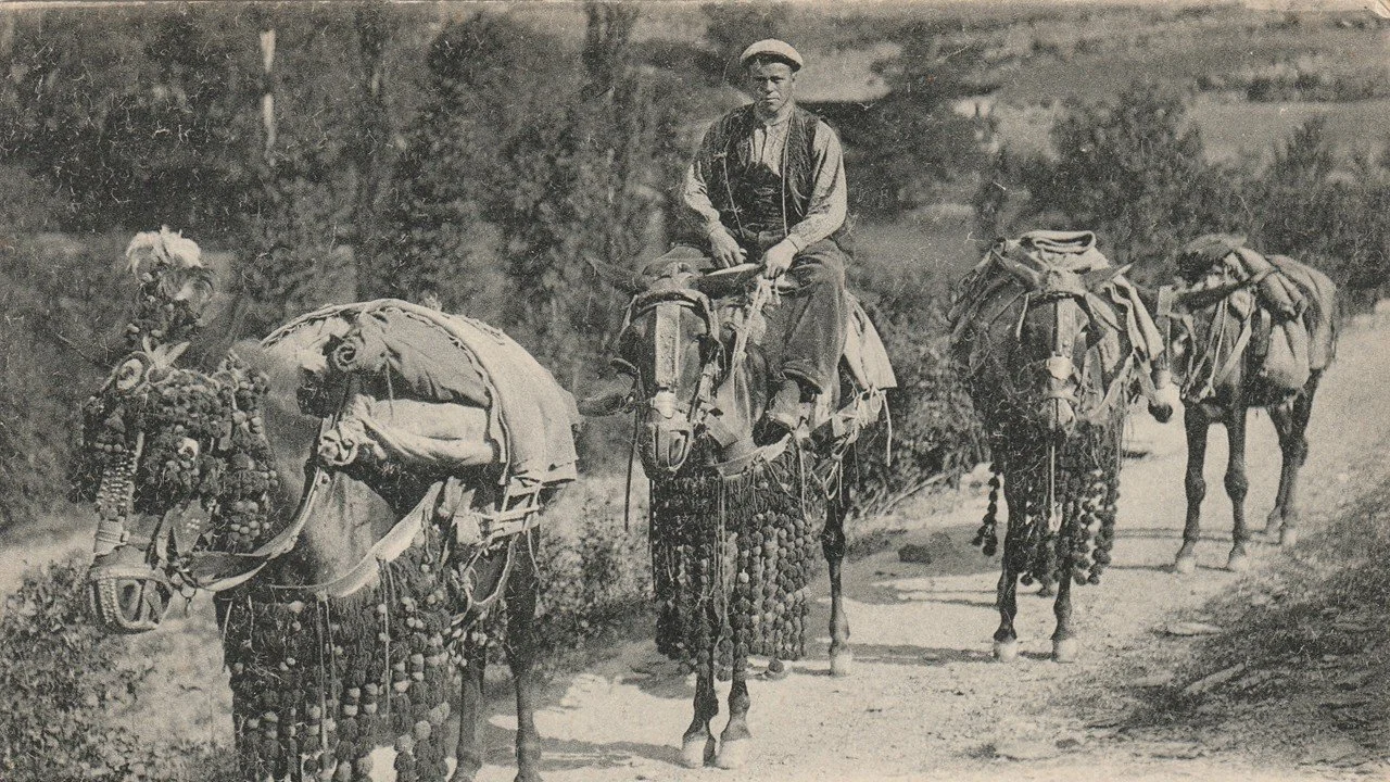 In this 1920s postcard, a youthful postman rides one of four mules carrying the mail uphill from La Seu d’Urgell to Andorra-la-Vella.