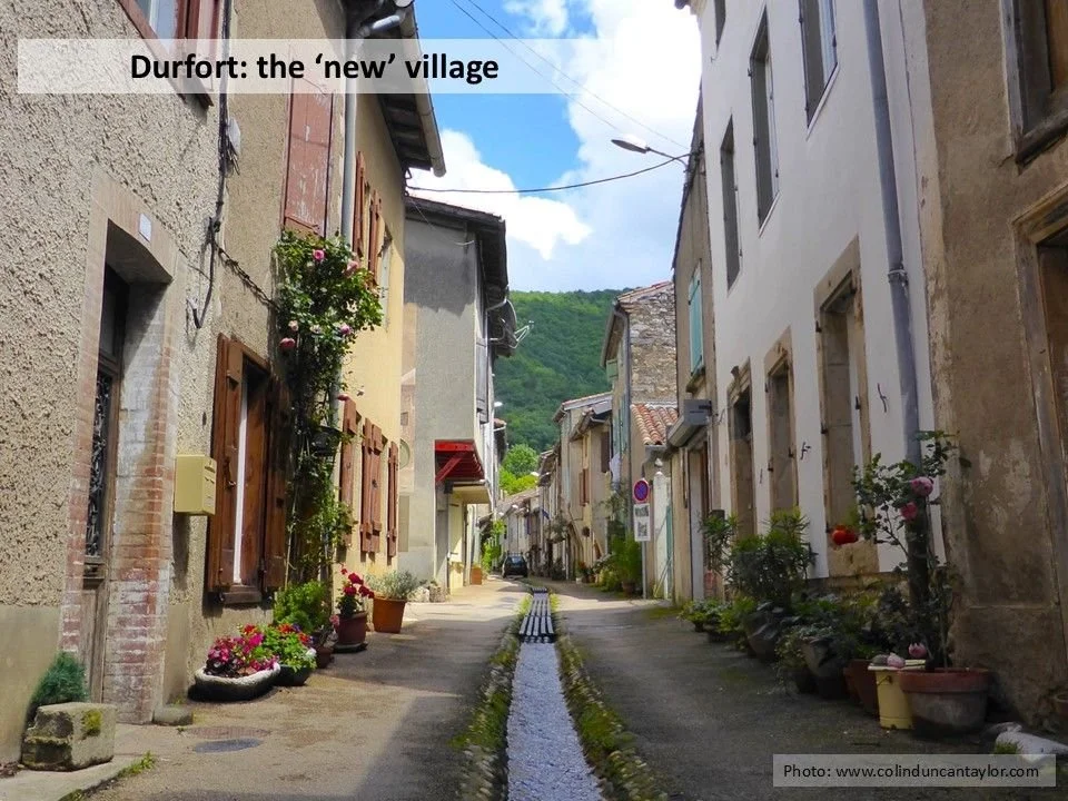 A pretty street in Durfort with a stream running down the middle of it.