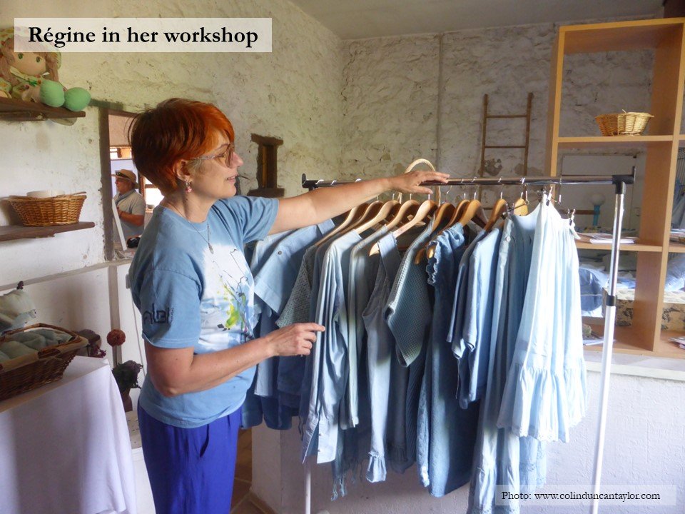Régine Berthoumieux and a rack of her woad or pastel dyed garments.