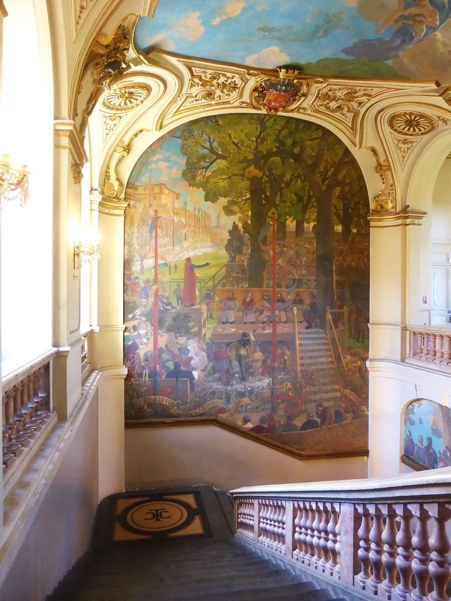 This mural on a staircase inside the Capitole, Toulouse, depicts the first Floral Games in 1324.