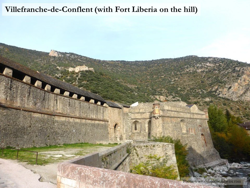 A view of the walls of Villefranche-de-Conflent with Fort Liberia on the hill behind it.