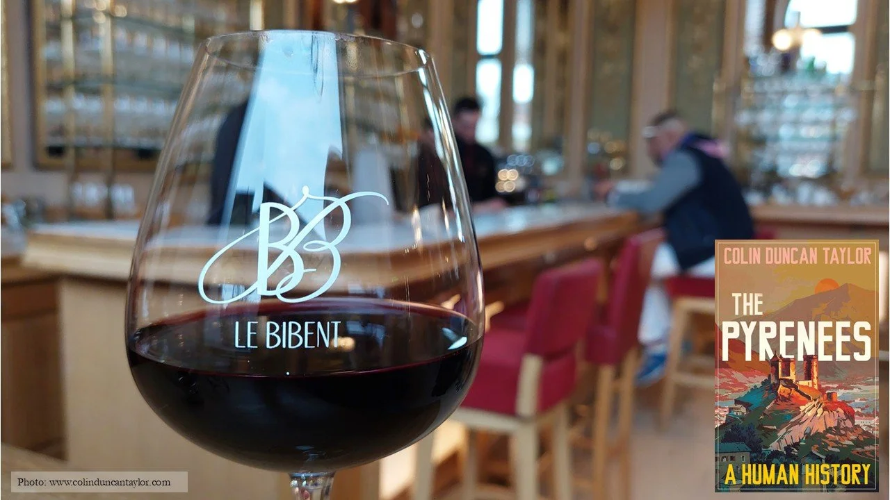 A glass of red wine against backdrop of Le Bibent's bar.