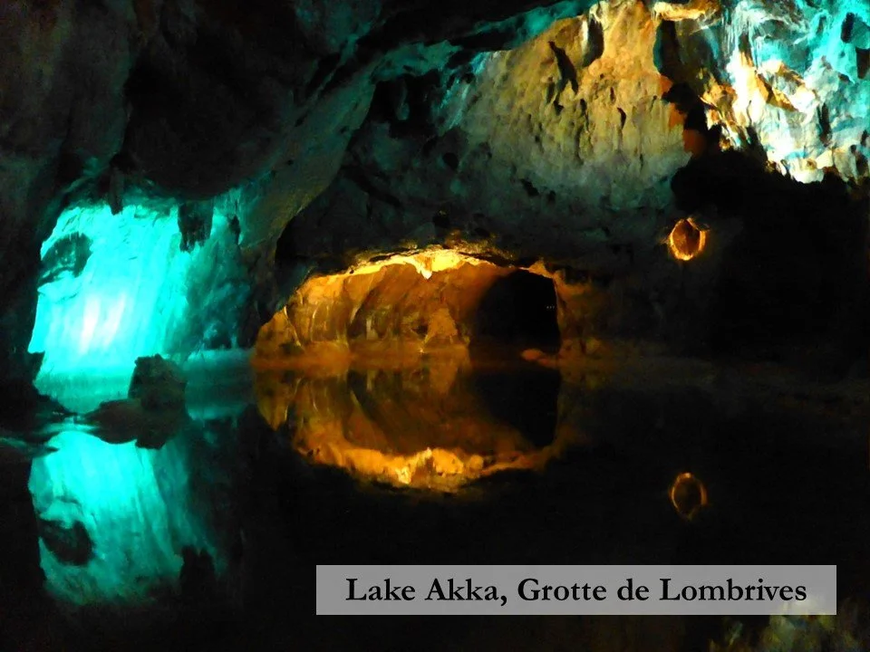 Lake Akka, one kilometre inside the Grotte de Lombrives glowing blue and yellow under artificial lights.