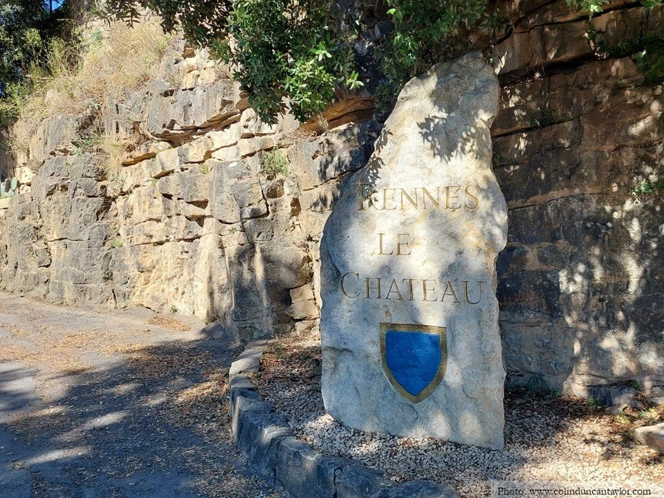 A standing stone carrying the arms and name of Rennes-le-Château.